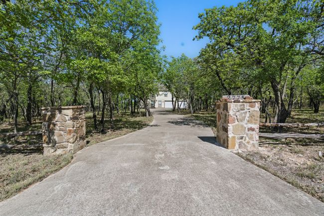 The house sits down a long drive that provides seclusion and ample parking. | Image 26