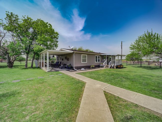 View of front of house featuring a front yard, a patio, house two. | Image 21