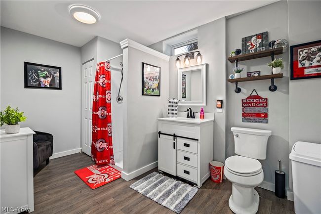 Bathroom featuring toilet, vanity, and hardwood / wood-style flooring | Image 35