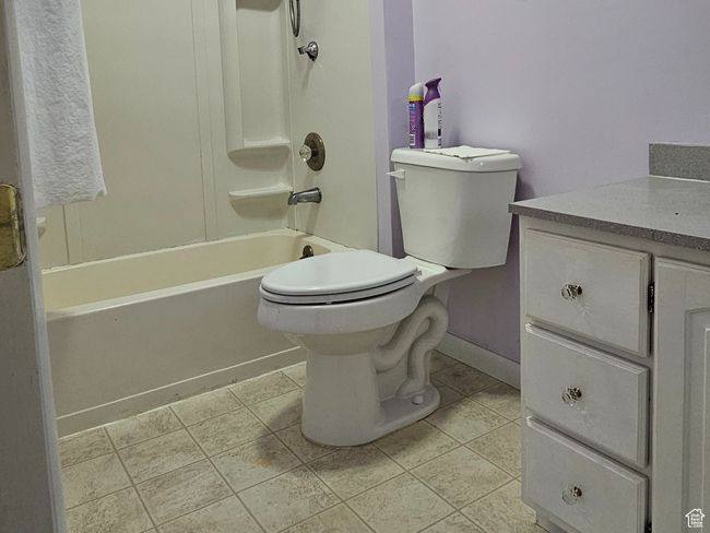 Full bathroom featuring shower / bathing tub combination, vanity, toilet, and tile patterned floors | Image 31