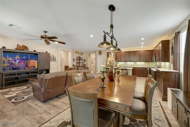Dining room featuring light wood-type flooring, a ceiling fan, recessed lighting, and visible vents | Image 11