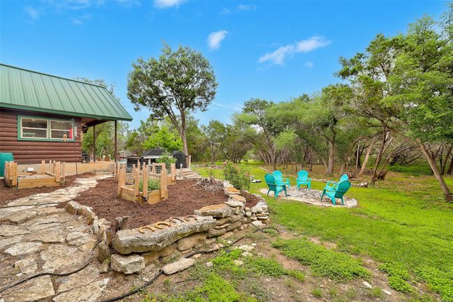 View of yard with a garden and a fire pit | Image 38