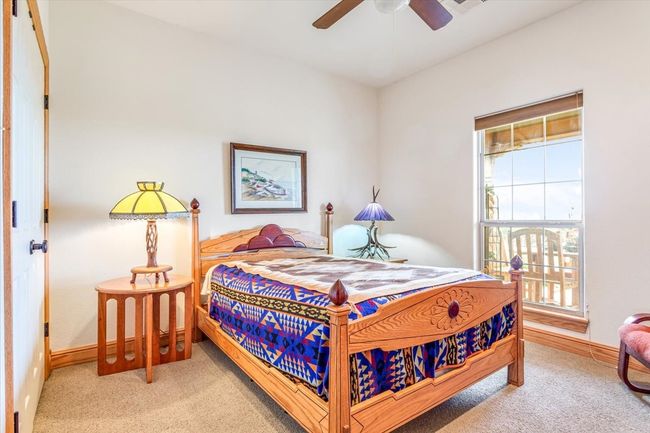 Carpeted bedroom featuring baseboards | Image 22
