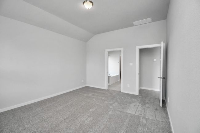 Come and unwind after a long day in this magnificent primary suite! This spacious room features plush carpet, warm paint, high ceilings and large windows with privacy blinds. | Image 23