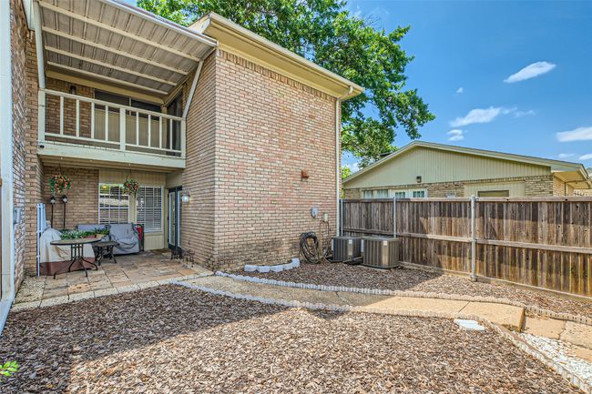 View of side of property with brick siding, a patio area, central AC, and a balcony | Image 24