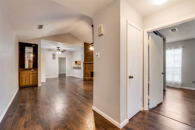 Hallway with dark wood-style floors and lofted ceiling | Image 21