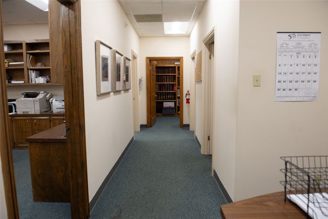 Hall featuring dark carpet, baseboards, and a paneled ceiling | Image 10