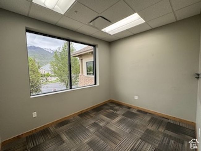 Unfurnished room with a paneled ceiling and carpet flooring | Image 33