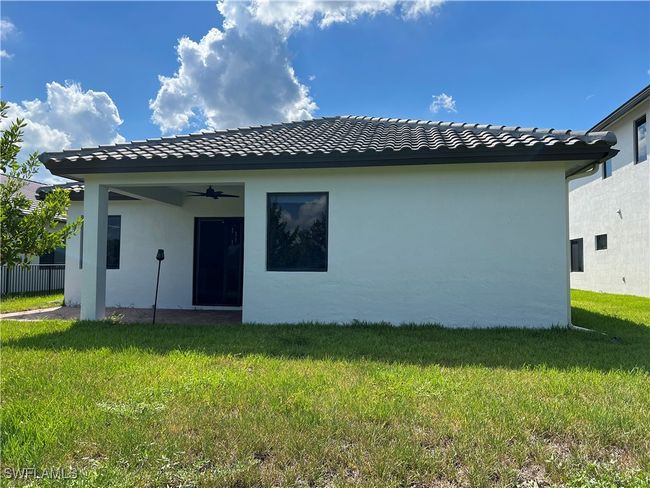 Back of house with a yard and ceiling fan | Image 32