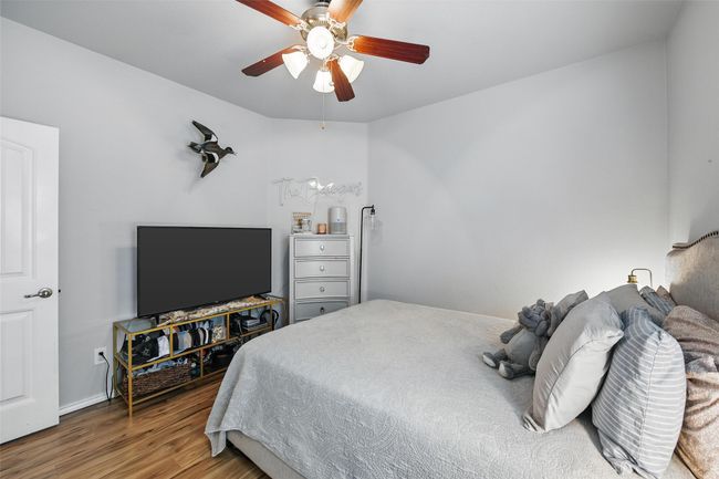 Bedroom featuring wood finished floors and a ceiling fan | Image 38