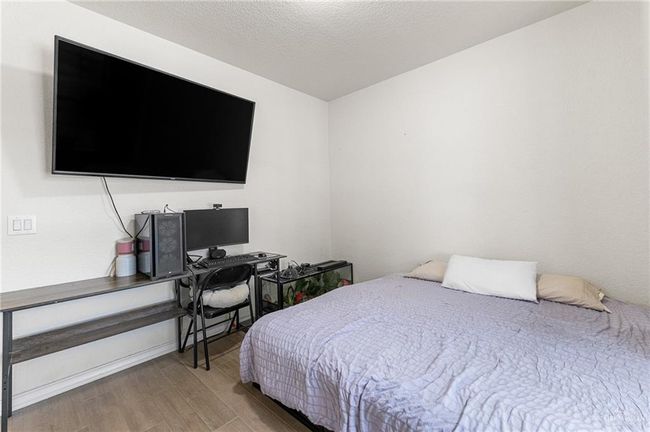 Bedroom featuring light wood-style floors and baseboards | Image 32