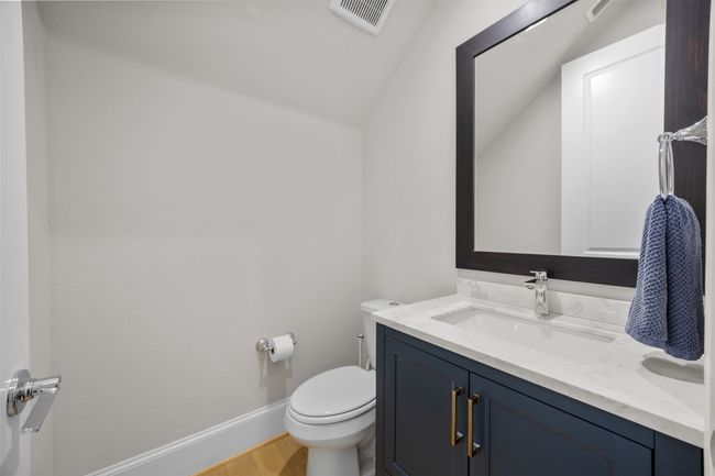 Bathroom featuring vanity, wood finished floors, and lofted ceiling | Image 12