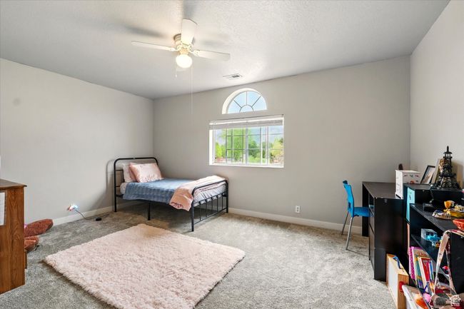 Bedroom with carpet floors and a ceiling fan | Image 27