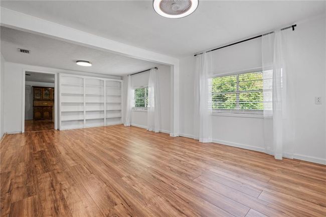 Unfurnished bedroom with wood finished floors | Image 7