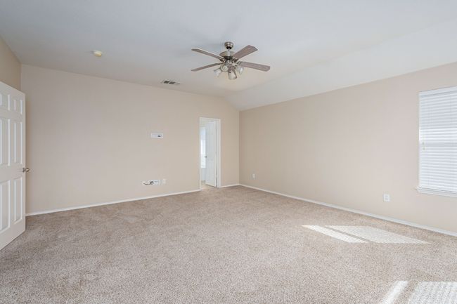 Unfurnished room with ceiling fan, light carpet, healthy amount of natural light, and lofted ceiling | Image 16
