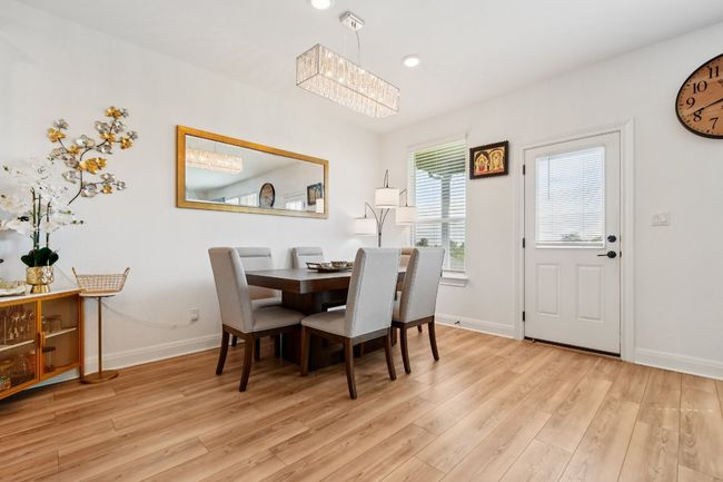 Dining room featuring wood finished floors, a chandelier, and recessed lighting | Image 5