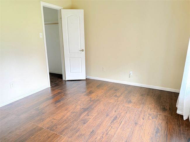 Unfurnished room featuring wood finished floors and baseboards | Image 4