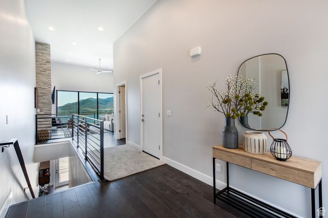 Foyer with a mountain view, ceiling fan, dark hardwood / wood-style flooring, and a towering ceiling | Image 4