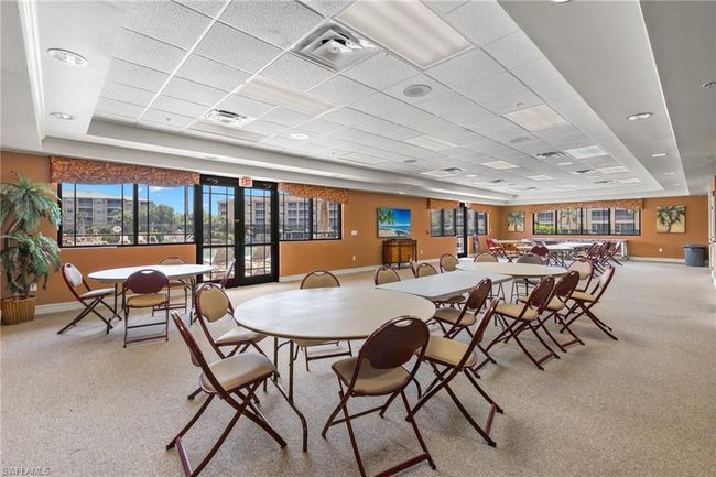 Carpeted dining space with a tray ceiling and a drop ceiling | Image 24