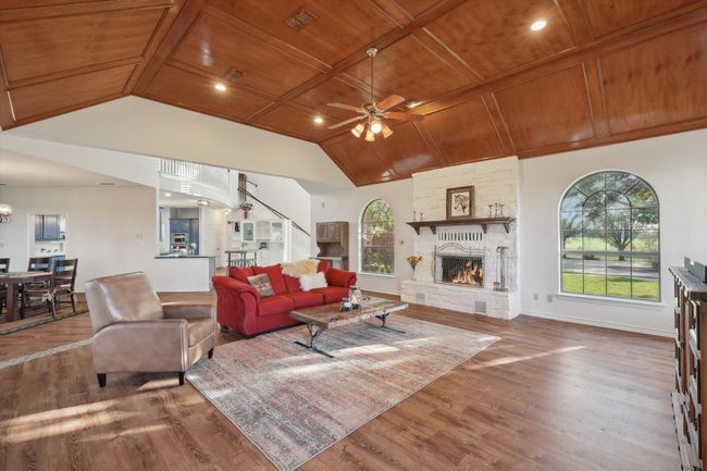 Living room with wood ceiling, lofted ceiling, a ceiling fan, wood finished floors, and healthy amount of natural light | Image 19