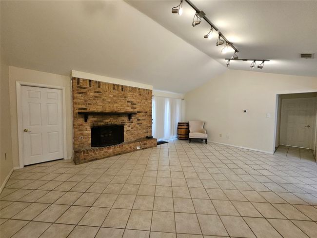 Living room with lofted ceiling and wood burning brick fireplace | Image 4