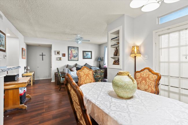 Dining room with ceiling fan, wood finished floors, and a textured ceiling | Image 6