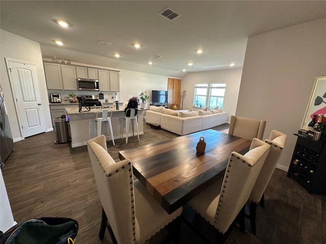 Dining space featuring dark Vinyl finished floors, recessed lighting, and baseboards | Image 4