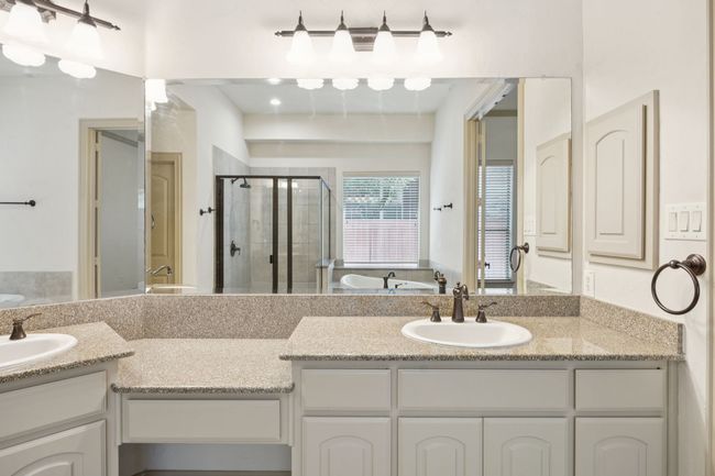 Bathroom featuring a shower stall, double vanity, and a garden tub | Image 22