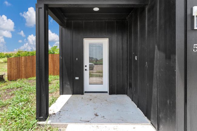 Doorway to property featuring board and batten siding and a patio area | Image 4