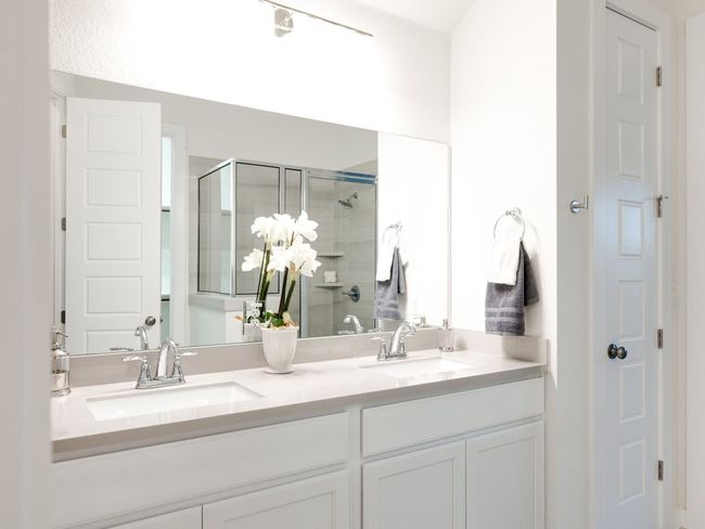 Bathroom featuring a stall shower and double vanity | Image 27