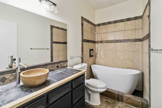 Full bathroom featuring a freestanding tub, vanity, and a shower | Image 12