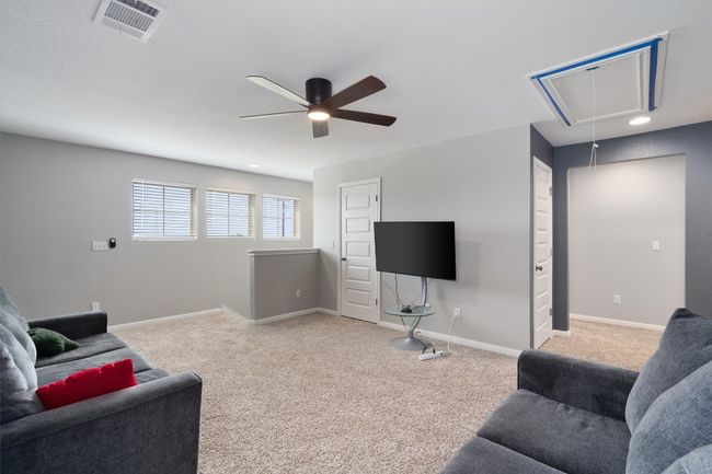 Living room featuring attic access, ceiling fan, and light colored carpet | Image 17