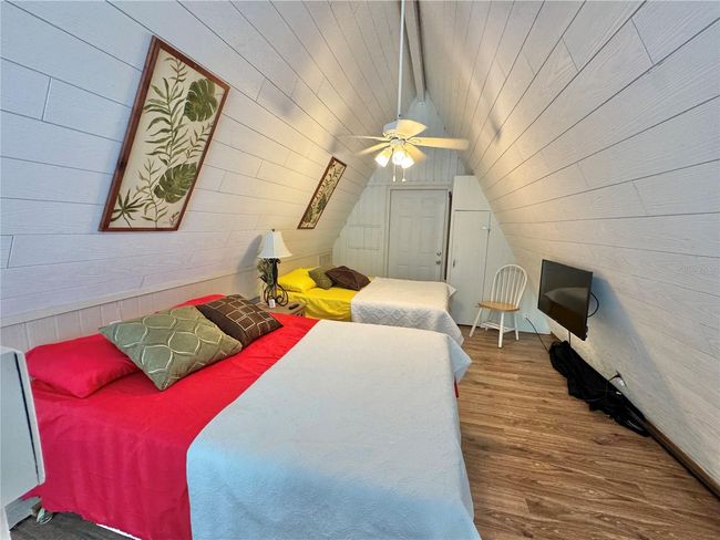 Spiral staircase to Loft bedroom with 2 beds and opens to outside balcony porch. | Image 30