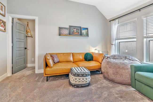 Living room featuring carpet floors and vaulted ceiling | Image 20