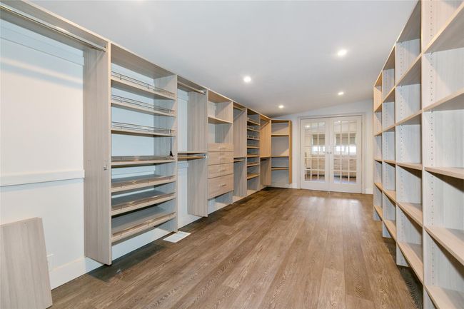 Spacious closet featuring wood finished floors and french doors | Image 17