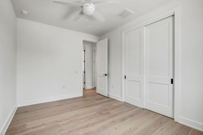 Unfurnished bedroom with light wood-type flooring, a closet, baseboards, and ceiling fan | Image 24