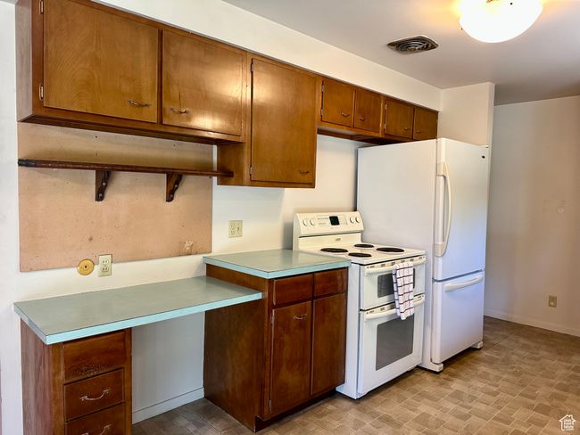 Kitchen featuring white appliances and light countertops | Image 7