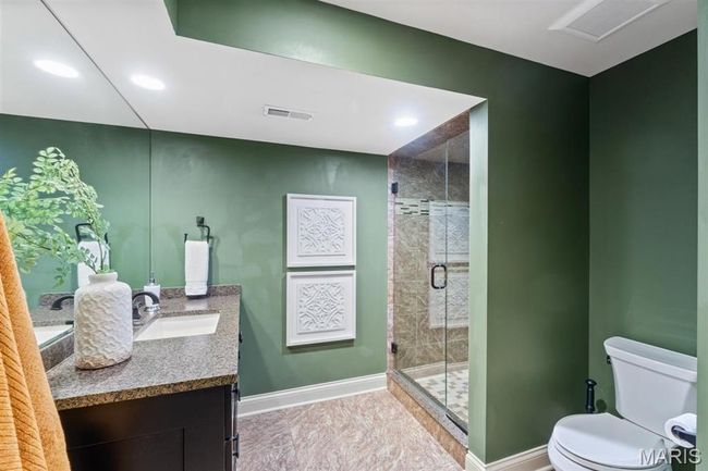 Bathroom featuring vanity, a shower stall, recessed lighting, and tile patterned floors | Image 55