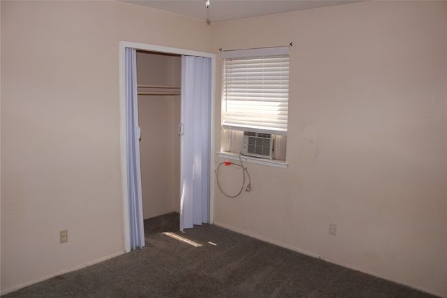 Unfurnished bedroom featuring carpet flooring and a closet | Image 9