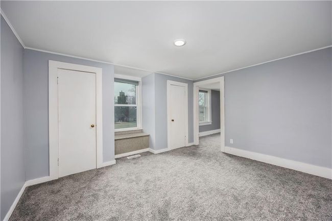 Empty room with visible vents, baseboards, carpet floors, and ornamental molding | Image 52