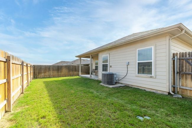 View of yard with central AC unit and a patio area | Image 40