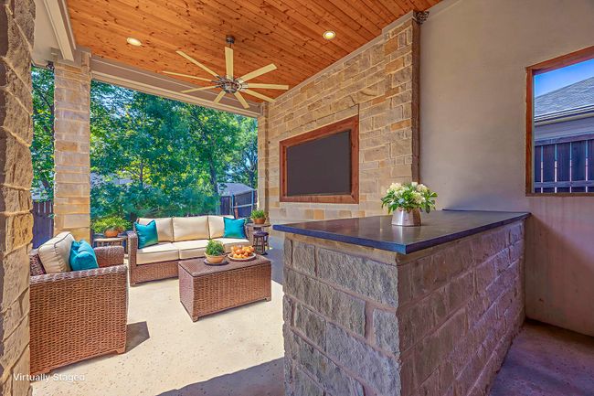 View of patio / terrace with a ceiling fan and an outdoor living space with a fireplace | Image 11
