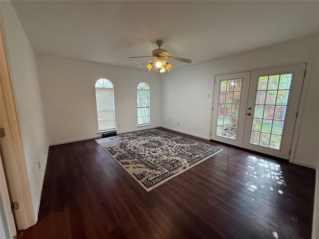 Spare room with wood finished floors, french doors, and a ceiling fan | Image 13