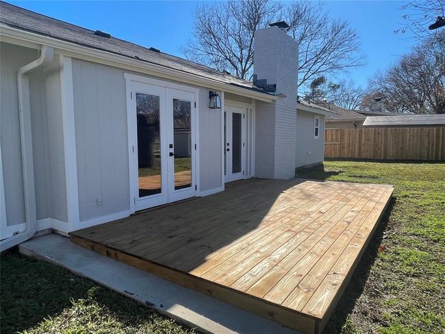 Wooden terrace featuring a yard, fence, and french doors | Image 17