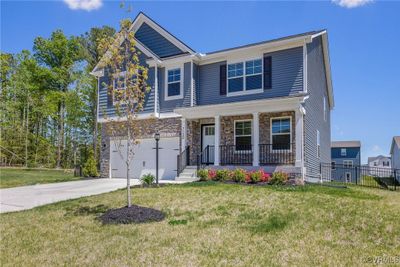 Craftsman-style home featuring a front yard, a porch, and a garage | Image 2