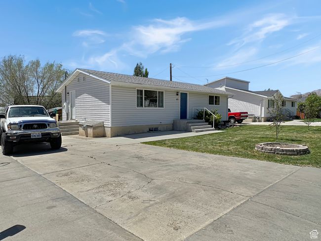 View of front of property featuring a front yard and concrete driveway | Image 33