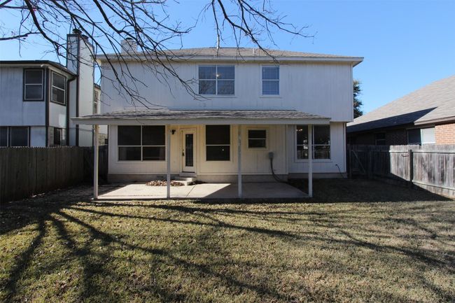 Back of house with a patio, a fenced backyard, a shingled roof, and a chimney | Image 21