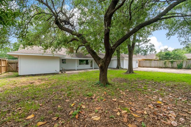View of nice size backyard with covered porch and the 2 car garage. | Image 6