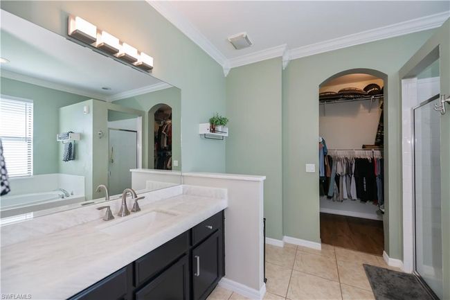 Bathroom with vanity, ornamental molding, a stall shower, and tile patterned floors | Image 16