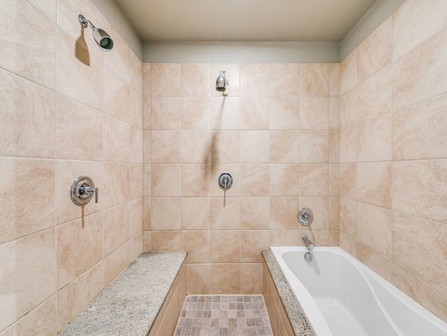 Full bathroom featuring tiled shower and tiled tub | Image 9